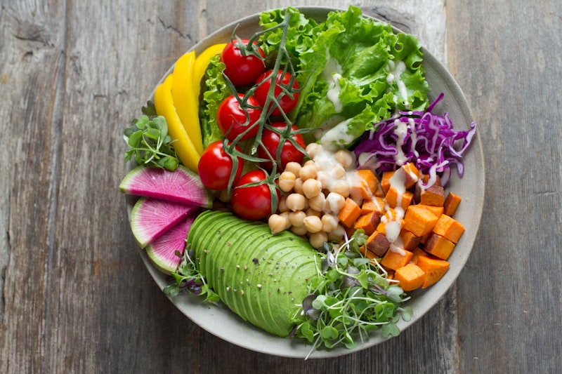 Colorful salad bowl with greens tomatoes and seeds